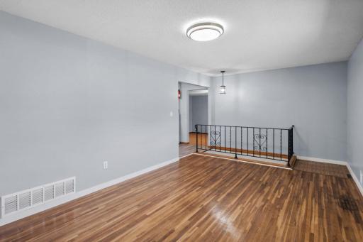 Beautifully refinished hardwood floors add warmth and character throughout the home