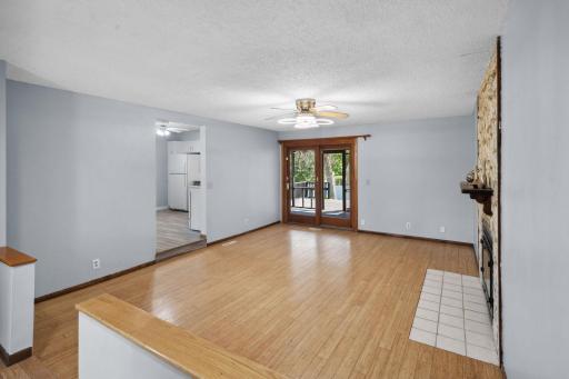 This bright and inviting living room offers a great view of the porch and backyard, letting in plenty of natural light.