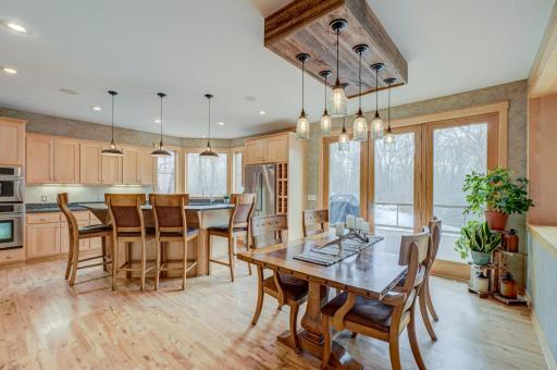 The eat in kitchen, complete with granite countertops, stainless steel appliances, a walk in pantry, and direct access to the expansive, maintenance free walkout deck.