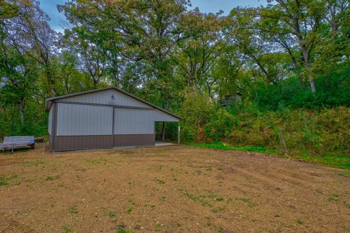 24x36 outbuilding with 10 ft doors and concrete floors and 9/lean