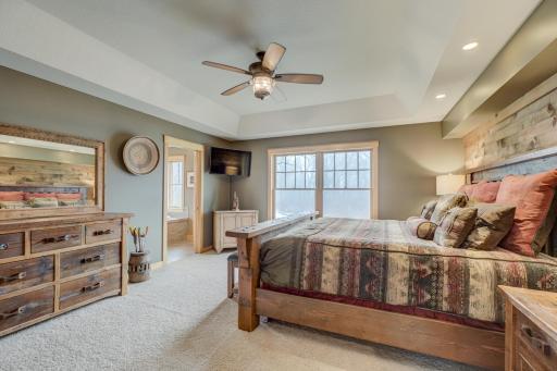 Serene primary suite with a spa like bath featuring in floor heat, a soaking tub, and a massive walk in closet.