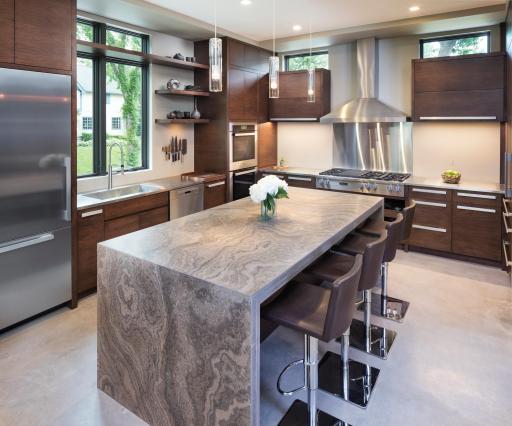 Kitchen waterfall island clad with Eramosa Limestone