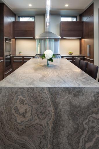 Kitchen waterfall island clad with Eramosa Limestone