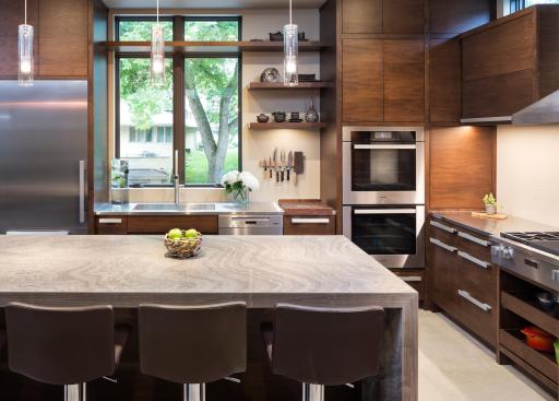 Kitchen with custom matching hardware and custom horizontal grain matched walnut cabinets