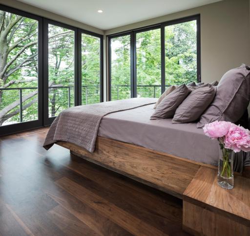 Primary bedroom has an incredible tree house feeling