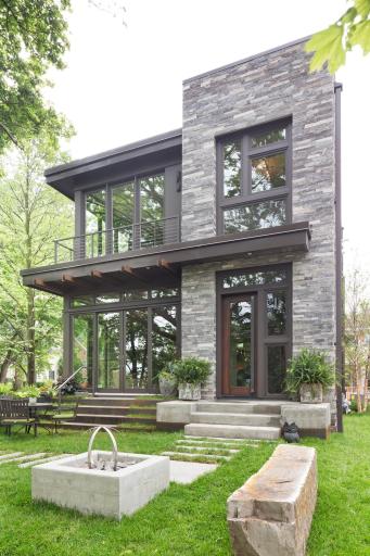 Built by award-winning John Kraemer & Sons, this residence seamlessly blends into its elevated lot, offering a sense of privacy despite its prime location.