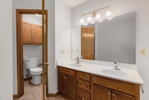 Primary bath with double sinks, freshly painted and updated light fixtures