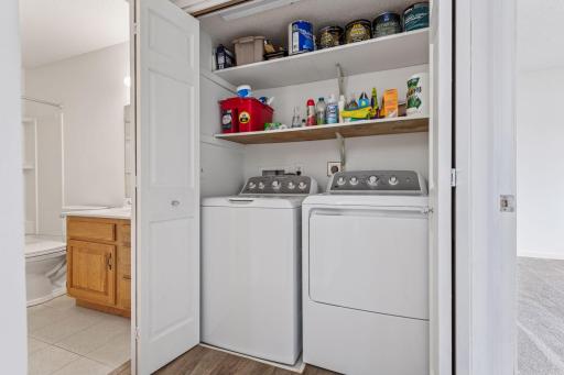 The conveniently located laundry closet, right off the bathroom, features newer machines and built-in storage!