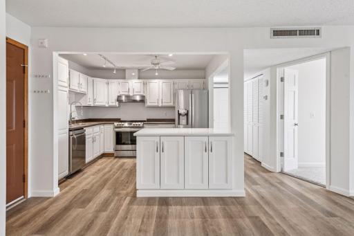 Bright and spacious kitchen with an inviting atmosphere for cooking and gathering! Stylish newer flooring!