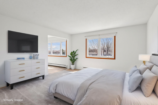 Large primary bedroom with lovely views and tons of natural light! *Virtually staged to show design options.