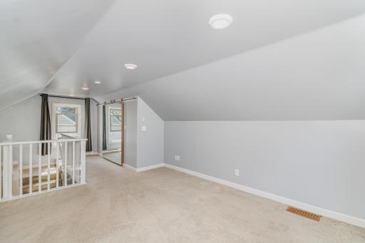 Generously sized upper bedroom with nice ceiling height and large closet