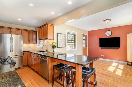 Open kitchen also features a rare peninsula and seating area