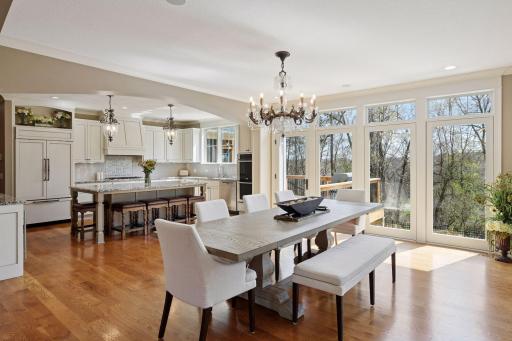 Dining and Kitchen area with windows overlooking backyard pool
