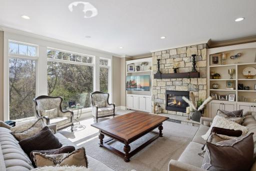 Living room with gas see-through fireplace into executive office