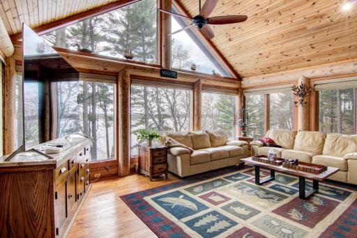 Incredible south facing sunroom with absolutely gorgeous lake views! Cozy in floor heat in this space along with a mini split to control temperatures.