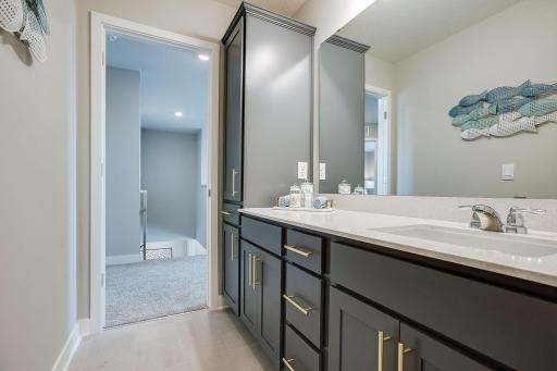 Upper level bathroom is intelligently designed with extra countertop space and cabinetry for more storage!