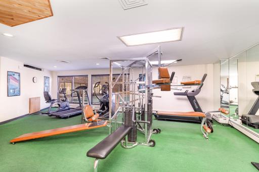 Community exercise room with sauna and separate bathrooms.