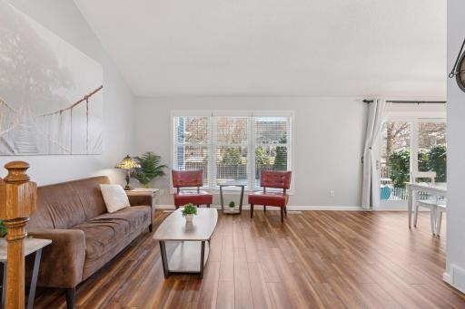 The living room boasts vaulted ceilings and abundant natural light