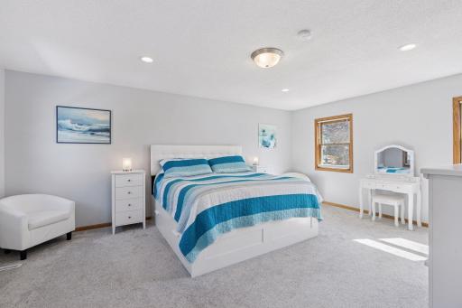 The primary en suite is a private retreat featuring a spacious bedroom, a versatile den or nursery, and a well-appointed bathroom. Designed for comfort and convenience, it offers a serene space to unwind.