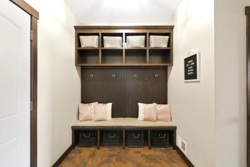 The mudroom, which is located behind the kitchen, connects to the oversized, heated 4-car garage and features a closet and plenty of room for people to take off their shoes and coats.
