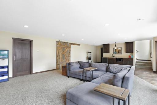 The intelligently designed lower level walks out to a massive paver patio and features a spacious family room with a wet bar, an easily accessible bathroom to serve the indoor and outdoor common areas, a huge storage room and a utility room.
