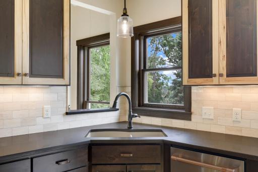 The chefâs kitchen, open to the dining and living rooms, features a Viking double oven with 6-burners + a griddle, custom fanhood which vents to the exterior, an oversized refrigerator, new dishwasher, pantry, a huge granite topped island & wet bar.