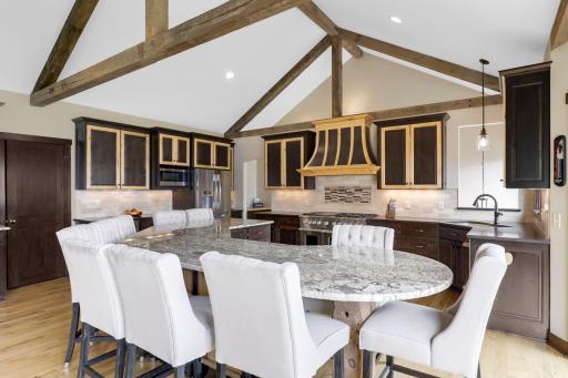 The chefâs kitchen, open to the dining and living rooms, features a Viking double oven with 6-burners + a griddle, custom fanhood which vents to the exterior, an oversized refrigerator, new dishwasher, pantry, a huge granite topped island & wet bar.