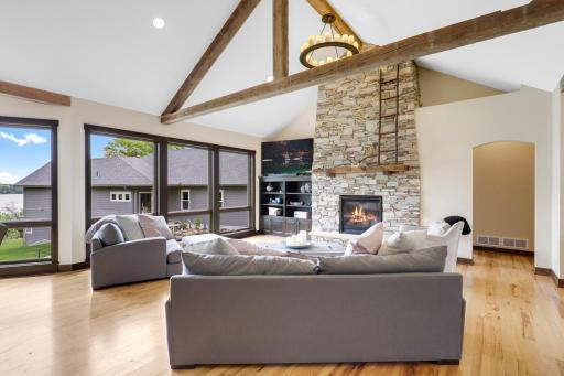 The main floor is spacious, bright and open with hickory hardwood floors, a gas fireplace in the living room, vaulted ceilings and a wall of windows facing east which provide expansive views of Lake Johanna.