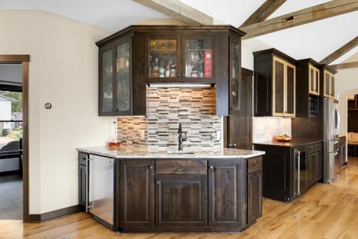 The chefâs kitchen, open to the dining and living rooms, features a Viking double oven with 6-burners + a griddle, custom fanhood which vents to the exterior, an oversized refrigerator, new dishwasher, pantry, a huge granite topped island & wet bar.