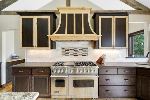 The chefâs kitchen, open to the dining and living rooms, features a Viking double oven with 6-burners + a griddle, custom fanhood which vents to the exterior, an oversized refrigerator, new dishwasher, pantry, a huge granite topped island & wet bar.