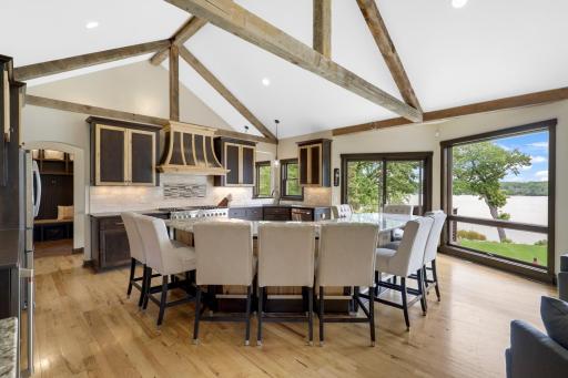 The chefâs kitchen, open to the dining and living rooms, features a Viking double oven with 6-burners + a griddle, custom fanhood which vents to the exterior, an oversized refrigerator, new dishwasher, pantry, a huge granite topped island & wet bar.