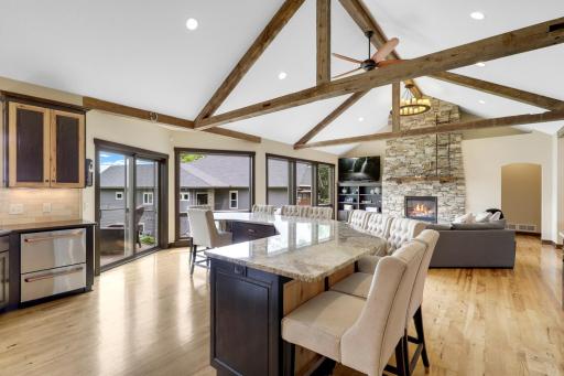The chefâs kitchen, open to the dining and living rooms, features a Viking double oven with 6-burners + a griddle, custom fanhood which vents to the exterior, an oversized refrigerator, new dishwasher, pantry, a huge granite topped island & wet bar.