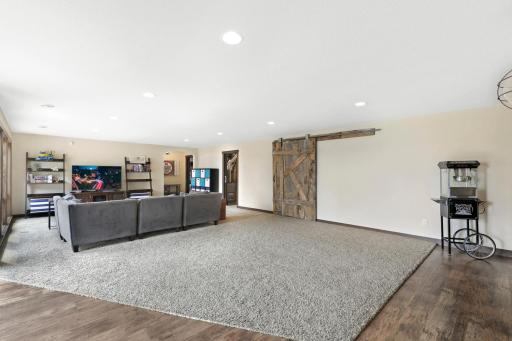 The intelligently designed lower level walks out to a massive paver patio and features a spacious family room with a wet bar, an easily accessible bathroom to serve the indoor and outdoor common areas, a huge storage room and a utility room.
