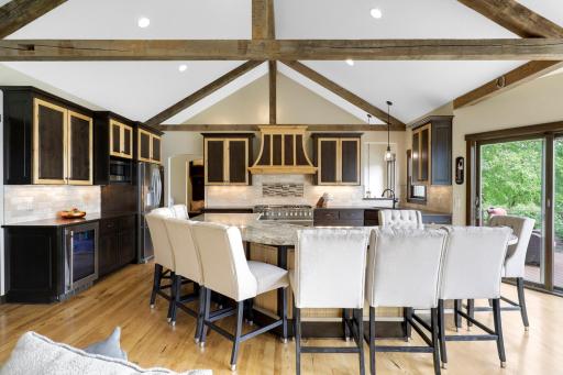 The chefâs kitchen, open to the dining and living rooms, features a Viking double oven with 6-burners + a griddle, custom fanhood which vents to the exterior, an oversized refrigerator, new dishwasher, pantry, a huge granite topped island & wet bar.