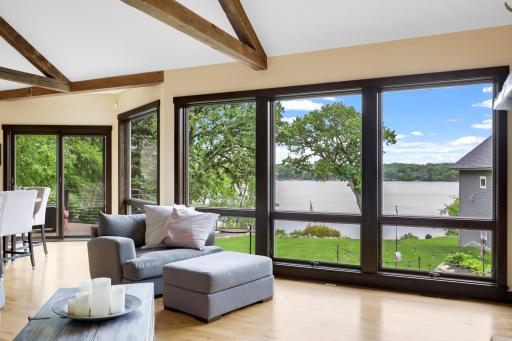 The main floor is spacious, bright and open with hickory hardwood floors, a gas fireplace in the living room, vaulted ceilings and a wall of windows facing east which provide expansive views of Lake Johanna.