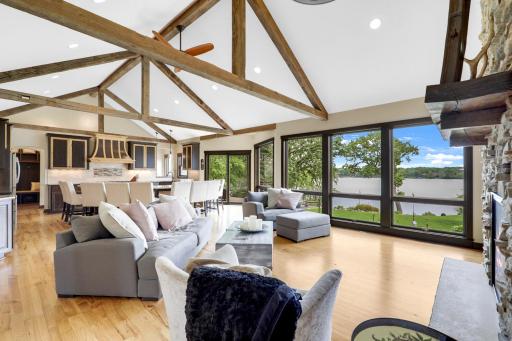 The main floor is spacious, bright and open with hickory hardwood floors, a gas fireplace in the living room, vaulted ceilings and a wall of windows facing east which provide expansive views of Lake Johanna.