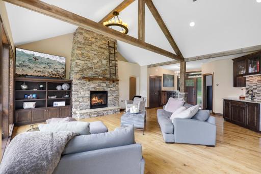 The main floor is spacious, bright and open with hickory hardwood floors, a gas fireplace in the living room, vaulted ceilings and a wall of windows facing east which provide expansive views of Lake Johanna.
