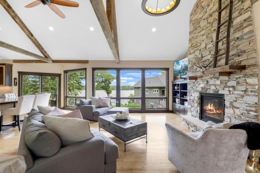 The main floor is spacious, bright and open with hickory hardwood floors, a gas fireplace in the living room, vaulted ceilings and a wall of windows facing east which provide expansive views of Lake Johanna.
