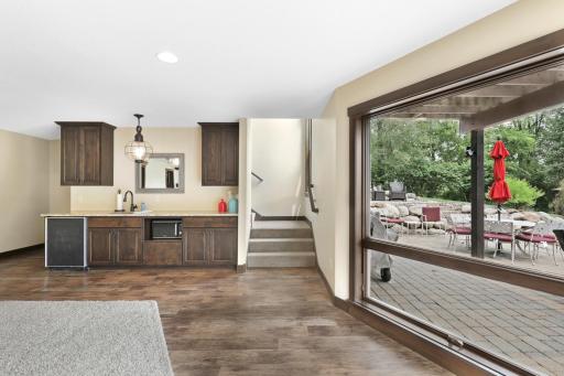 The intelligently designed lower level walks out to a massive paver patio and features a spacious family room with a wet bar, an easily accessible bathroom to serve the indoor and outdoor common areas, a huge storage room and a utility room.