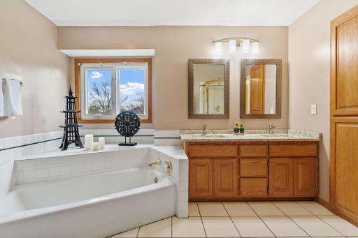 Dual vanities and large soaker tub make this primary bathroom a true retreat.