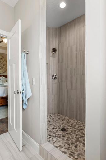 The primary ensuite bathroom includes a gorgeous tiled walk-in shower.