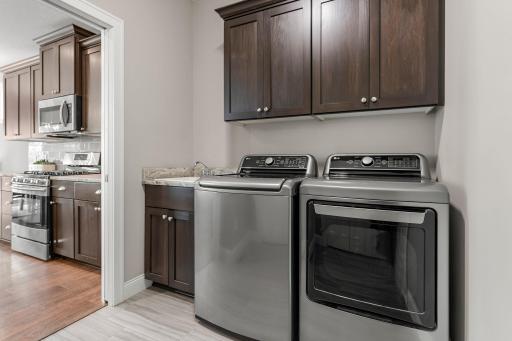 The laundry room includes a sink and additional cabinet space.