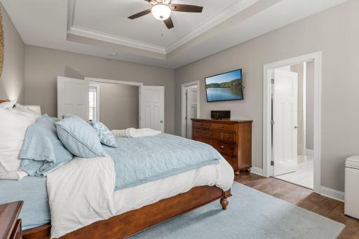 The primary bedroom includes a large walk-in closet, a private ensuite bathroom and a tray ceiling.