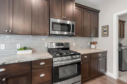 The leathered marble countertops and tile backsplash give this kitchen a true touch of elegance.