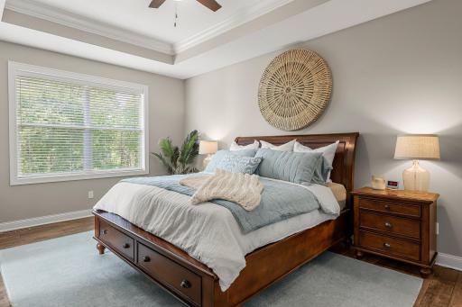 The primary bedroom includes a large walk-in closet, a private ensuite bathroom and a tray ceiling.