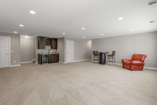 The family room includes a wet bar, complete with leathered marble countertop.