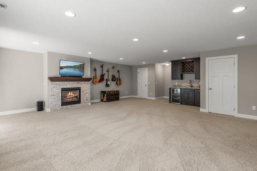 The family room includes a wet bar, complete with leathered marble countertop.