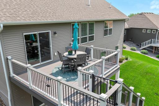 The maintenance free deck offers access to the tree-lined backyard and the concrete patio.