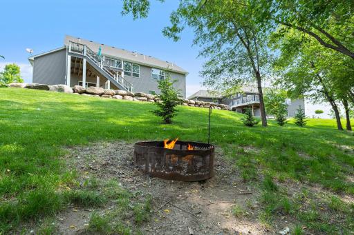 The backyard is lined with trees to add additional privacy.