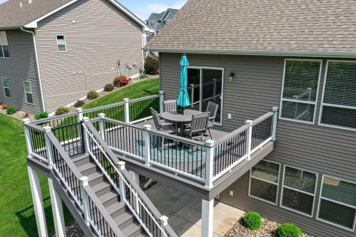 The maintenance free deck offers access to the tree-lined backyard and the concrete patio.